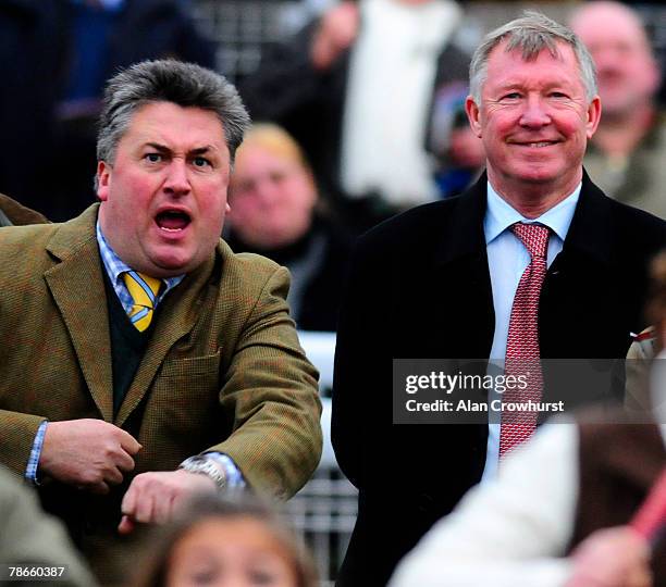 Owner Sir Alex Ferguson and trainer Paul Nicholls watch as What a Friend wins at Chepstow Racecourse on December 27, 2007 in Chepstow, Wales.