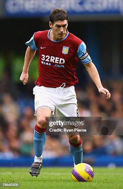 Gareth Barry of Aston Villa runs with the ball during the Barclays Premier League match between Chelsea and Aston Villa at Stamford Bridge on...