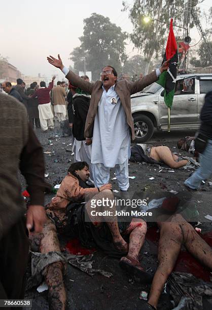 Survivor grieves over the dead and wounded following a bomb blast attack on former Prime Minister Benazir Bhutto December 27, 2007 following a...