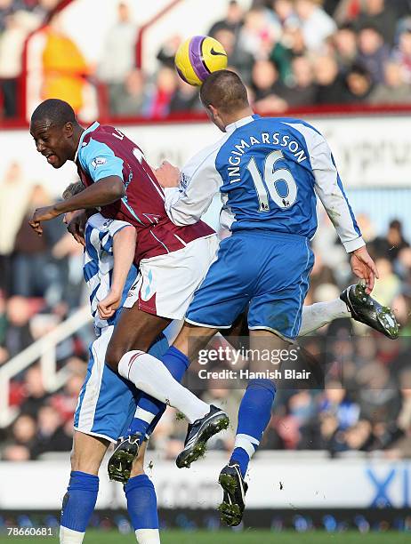 Brynjar Gunnarsson of Reading pushes into the back of Carlton Cole of West Ham as he heads the ball during the Barclays Premier League match between...