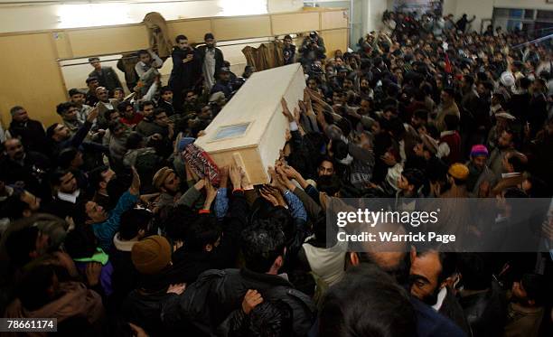 The body of former Prime Minister Benazir Bhutto is carried out of Rawalpindi General Hospital on December 27, 2007 in Rawalpindi, Pakistan. The...