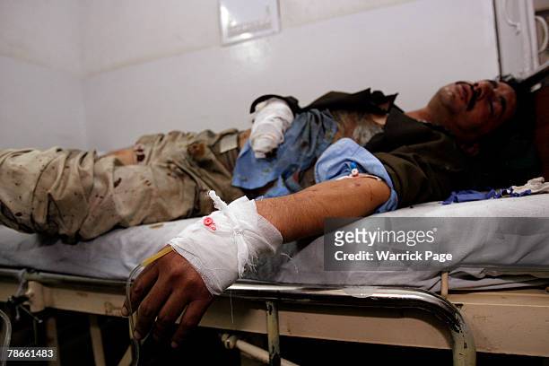 Pakistan People's Party supporter lies wounded in the Rawalpindi District Hospital on December 27, 2007 in Rawalpindi, Pakistan.Former prime minister...