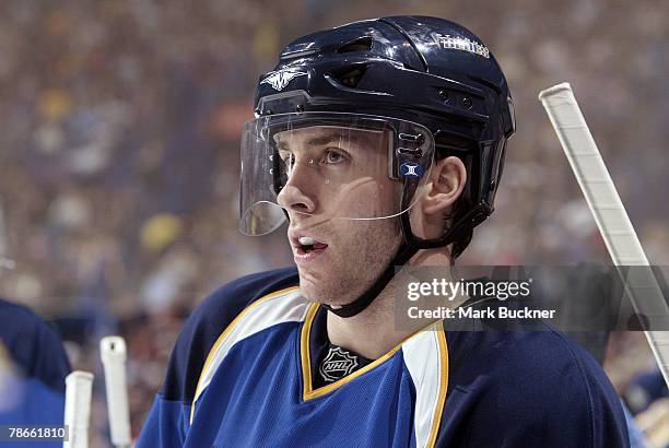 Andy McDonald of the St. Louis Blues waits near the Blues bench during a time out at a game against the Detroit Red Wings on December 26, 2007 at...