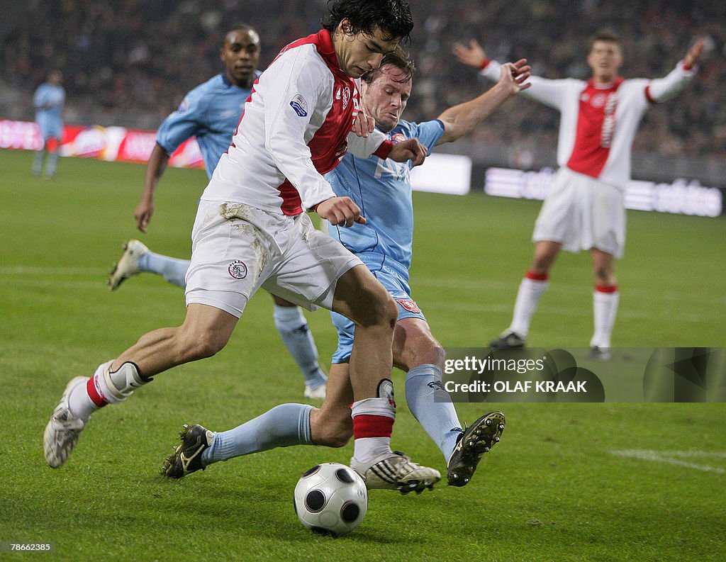 Luis Suarez of Ajax Amsterdam (L) duels