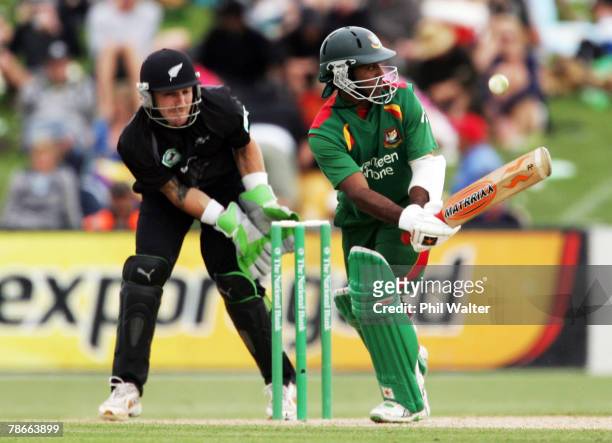 Aftab Ahmed of Bangladesh lobs the ball over the top of Brendon McCullum of New Zealand during the second one day international match between New...