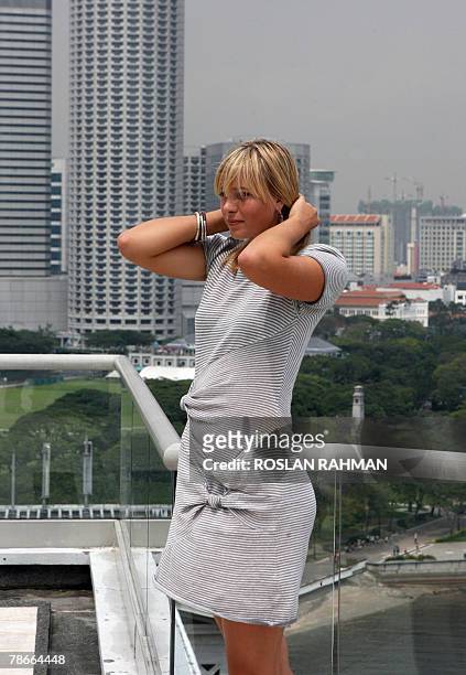 Russian Maria Sharapova, one of the top world tennis player stands during a photo session on the roof of a hotel in Singapore, 28 December 2007. The...