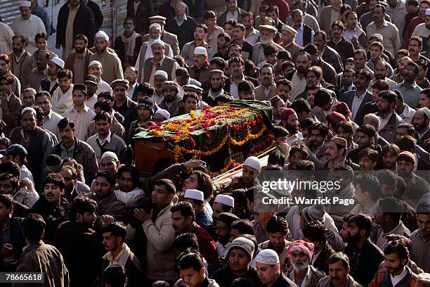 Mourners carry a coffin during a funeral procession for a Pakistan People's Party member killed yesterday in a suicide blast, on December 28, 2007 in...