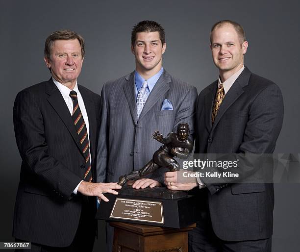 Quarterback Tim Tebow of the University of Florida poses with the Heisman Trophy and Steve Spurrier and 1996 Heisman Trophy Winner Danny Wuerffel ....