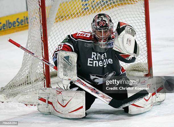 Goalie Robert Mueller of the Haie saves the puck during the DEL game between Koelner Haie and Hamburg Freezers at the Koelnarena on December 28, 2007...