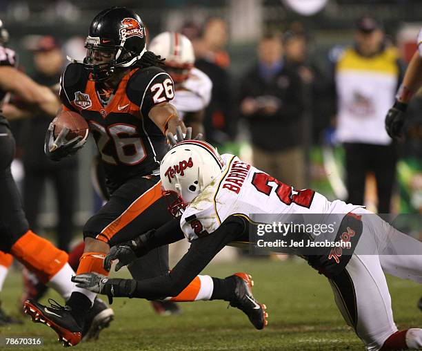 Yvenson Bernard of the Oregon State Beavers runs against Kevin Barnes of the Maryland Terrapins during the Emerald Bowl at AT&T Park December 28,...