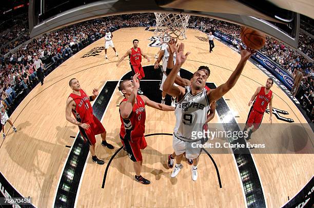 Tony Parker of the San Antonio Spurs shoots against Kris Humphries of the Toronto Raptors at the AT&T Center December 28, 2007 in San Antonio, Texas....