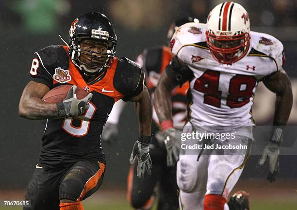 James Rodgers of the Oregon State Beavers runs against Moise Fokou of the Maryland Terrapins during the Emerald Bowl at AT&T Park December 28, 2007...