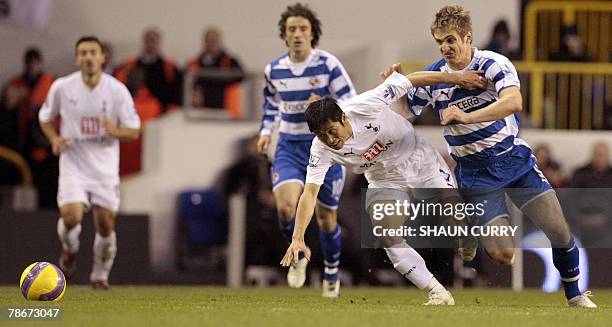 South Korean, Tottenham footballer Young-Pyo Lee tackles Reading Ibra Sonko during a Premiership football match at the Tottenham ground in North...