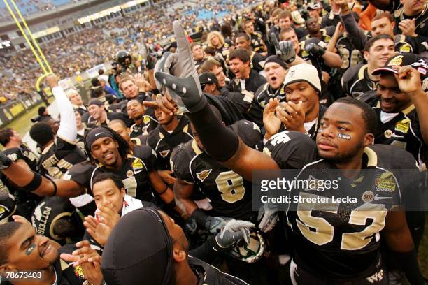 Dominique Midgett of the Wake Forest Demon Deacons celebrates with teammates after defeating the Connecticut Huskies 24-10 during their game at Bank...