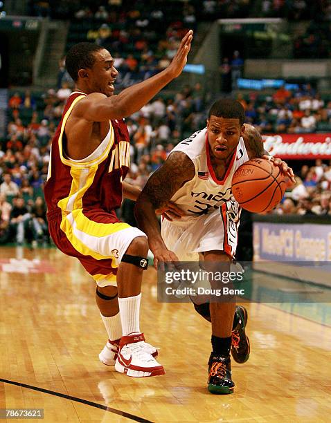 Jack McClinton of the Miami Hurricanes is fouled by Chris Gaynor of the Winthrop Eagles in the Orange Bowl Basketball Classic at Bank Atlantic Center...