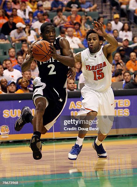 Ryan Brooks of the Temple Owls drives past Walter Hodge of the Florida Gators in the Orange Bowl Basketball Classic at Bank Atlantic Center on...