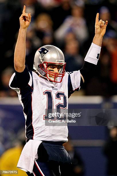 Tom Brady and the New England Patriots celebrates after throwing his 49th touchdown of the season tying the all time season high for touchdowns in a...