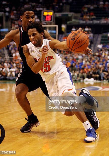 Walter Hodge of the Florida Gators drives past Luis Guzman of the Temple Owls in the Orange Bowl Basketball Classic at Bank Atlantic Center on...