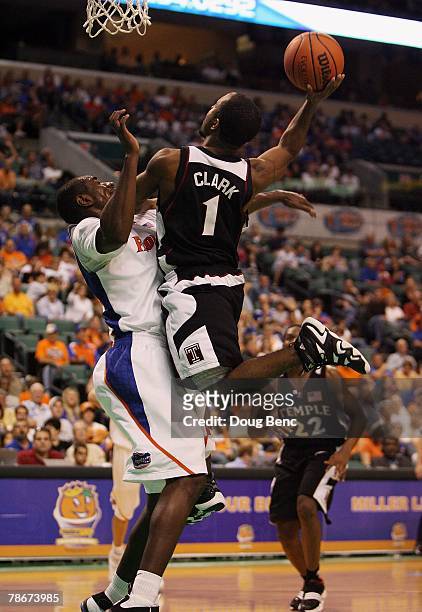 Chris Clark of the Temple Owls is fouled by Jonathan Mitchell of the Florida Gators in the Orange Bowl Basketball Classic at Bank Atlantic Center on...