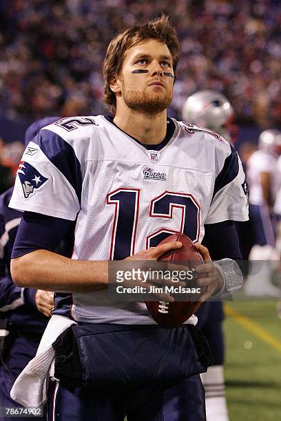 Tom Brady of the New England Patriots looks on from the sidelines against the New York Giants on December 29, 2007 at Giants Stadium in East...
