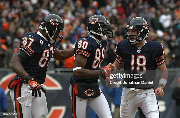 Muhsin Muhammad, Bernard Berrian and Kyle Orton of the Chicago Bears celebrate after Berrian scored 9 yard touchdown reception on a halfback pass by...