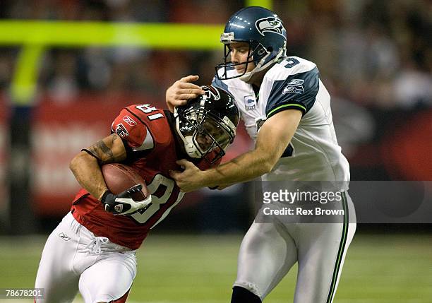 Adam Jennings of the Atlanta Falcons works to fight off Josh Brown of the Seattle Seahawks on this second half punt return at Georgia Dome on...