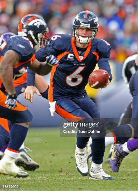 Quarterback Jay Cutler of the Denver Broncos hands off the ball at an NFL game against the Minnesota Vikings at Invesco Field at Mile High December...