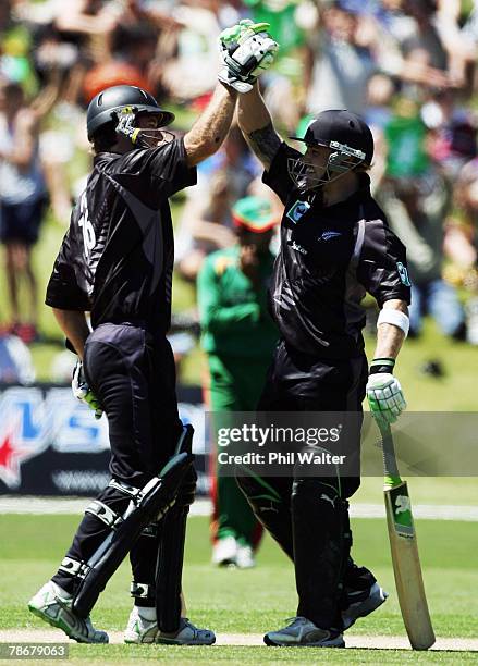 Brendon McCullum and Jamie How of New Zealand celebrate winning the third one day international match between New Zealand and Bangladesh at...