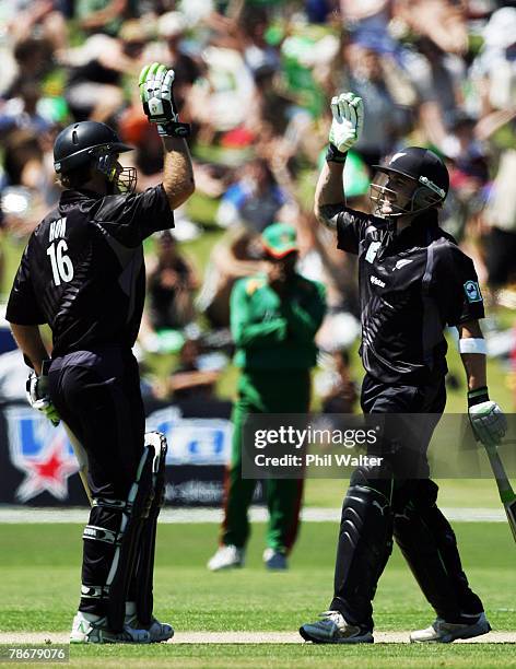 Brendon McCullum and Jamie How of New Zealand celebrate winning the third one day international match between New Zealand and Bangladesh at...