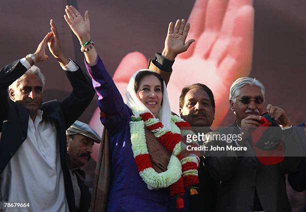 Former Prime Minister Benazir Bhutto waves to supporters at a campaign rally December 27, 2007 in Rawalpindi, Pakistan. She was assassinated as she...