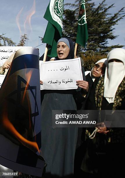 Flames rise from an Israeli flag as Jordanians protest in Amman against Israeli sanctions imposed on the Gaza Strip 31 December 2007. Six months...