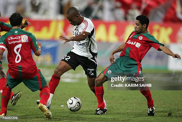 Emirati al-Jazira club player Bonaventure Kalou vies for the ball with Saudi al-Ittifaq club players Jamahan Mohammed and Ali Salman during their GCC...