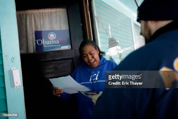Volunteer Lou Takacs , of Pittsburgh, Pennsylvania, speaks to undecided voter Annette Brown December 31, 2007 in Des Moines, Iowa. A group of...