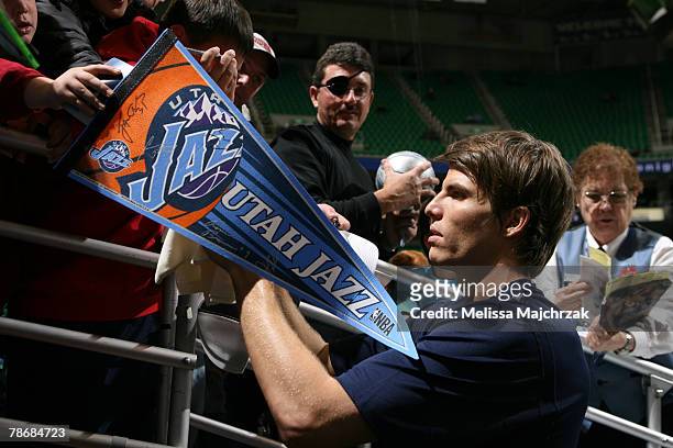 Kyle Korver of the Utah Jazz signs autographs for his new team fans prior to the game against the Portland Trail Blazers at EnergySolutions Arena on...