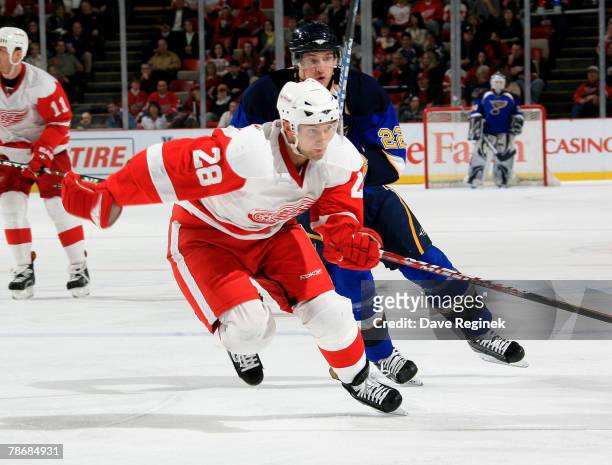 Brian Rafalski of the Detroit Red Wings skates after the puck as Brad Boyes is close behind during a NHL game against the St. Louis Blues at Joe...