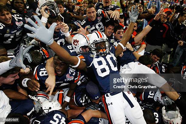 Members of the Auburn University Tigers celebrate after defeating the Clemson Univeristy Tigers 23-20 in overtime during the Chick-Fil-A Bowl on...