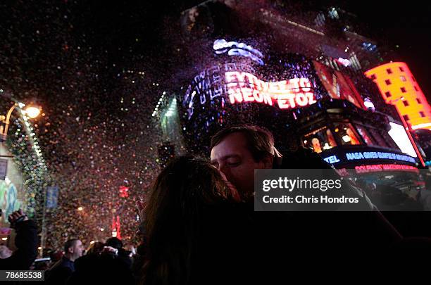 Couple kisses just after midnight during the New Year's Eve celebration in Times Square December 31, 2007 in New York. Many tourists stand for twelve...