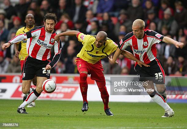 Marlon King of Watford is challenged by Alan Bennett and Andrew Davies of Southampton during the Coca-Cola Championship match between Southampton and...