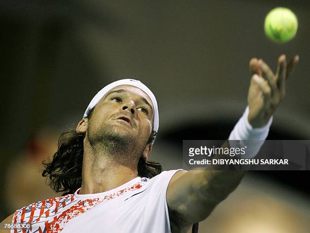 Carlos Moya of Spain serves to his unseen opponent Teimuraz Gabashvili of Russia during their first round match at The ATP Chennai Open 2008, in...