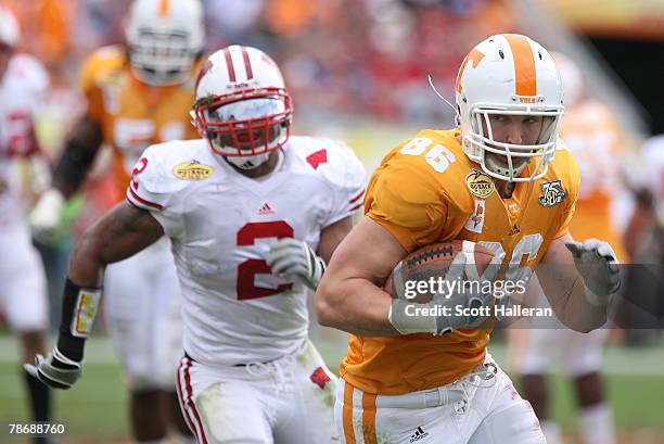 Brad Cottam of the Tennessee Volunteers runs for a first half touchdown past Jonathan Cassilas of Wisconsin Badgers during the Outback Bowl at...