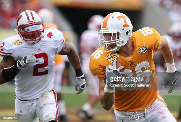 Brad Cottam of the Tennessee Volunteers runs for a first half touchdown past Jonathan Cassilas of the Wisconsin Badgers during the Outback Bowl at...