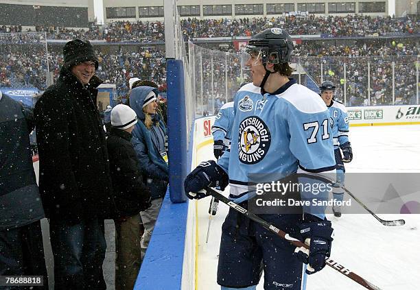 Great Mario Lemieux talks to Evgeni Malkin of the Pittsburgh Penguins during warm ups prior to the start of the NHL Winter Classic between the...