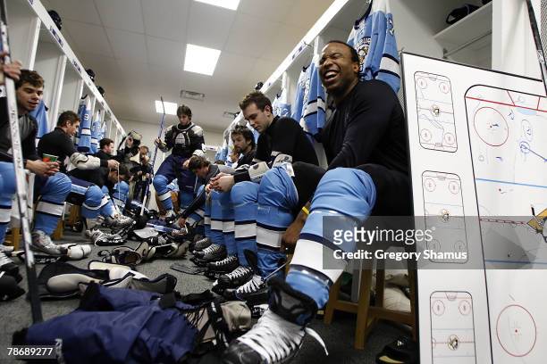 Georges Laraque of the Pittsburgh Penguins laces up his skates prior to the start of the NHL Winter Classic on January 1, 2008 at Ralph Wilson...
