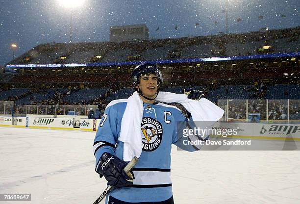 Sidney Crosby of the Pittsburgh Penguins smiles as he skates on the ice after scoring the winning shoot out goal in the NHL Winter Classic against...