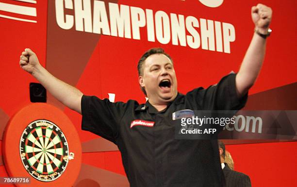 Canada's John Part celebrates a 7-2 victory over English qualifier Kirk Shepherd in the finals of the World Darts Championship at Alexandra Palace,...