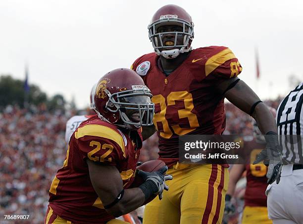 Running back Desmond Reed of the USC Trojans celebrates his touchdown against the Illinois Fighting Illini in the first quarter as teammate Fred...