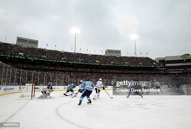 Weather looms as the Buffalo Sabres get the puck out of their zone in the second period of the NHL Winter Classic against the Pittsburgh Penguins at...