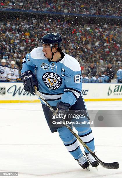 Sidney Crosby of the Pittsburgh Penguins skates with the puck in the third period of the NHL Winter Classic against the Buffalo Sabres at the Ralph...