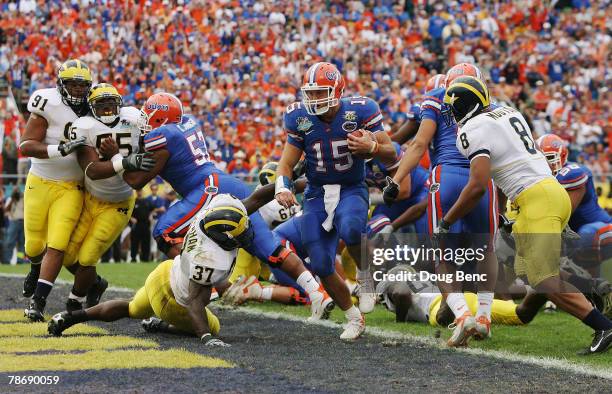 Quarterback Tim Tebow of the Florida Gators scores a touchdown in the third quarter while taking on the Michigan Wolverines in the Capital One Bowl...