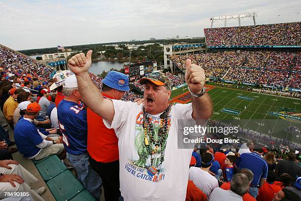 Gator Fan John Martin tries to get fans to cheer louder as the Michigan Wolverines take on the Florida Gators in the Capital One Bowl at Florida...